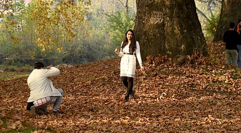 Tourists enjoying autumn, that sets in September and lasts till November end also known as Golden Season when colour of flora turns gold, in Srinagar, Kashmir on Monday, November 13, 2023.