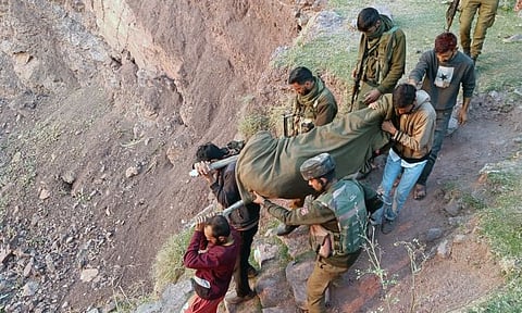 Security personnel recover the body of the terrorist killed in ongoing Rajouri encounter, in Rajouri, Jammu region on Thursday, November 23, 2023. ANI Photo
