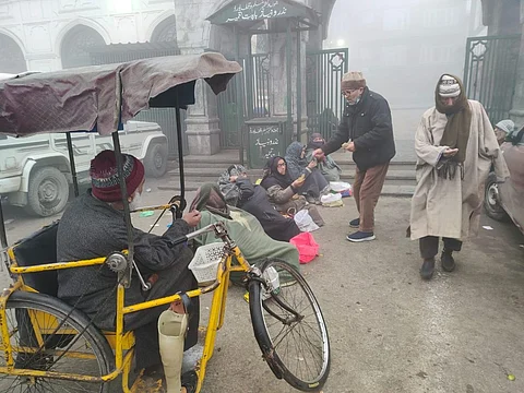 Some beggers seeking alms from passers-bye outside Jama Masjid in Srinagar on a foggy Friday, December 29, 2023. KT Photo/Qazi Irshad