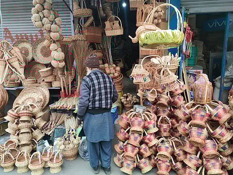 A shopkeeper selling different varieties of Kangris, traditional fire-pots with colourful wicker designs in Srinagar city of Kashmir as cold wave intensifies on Saturday, December 02, 2023. KT Photo/Qazi Irshad
