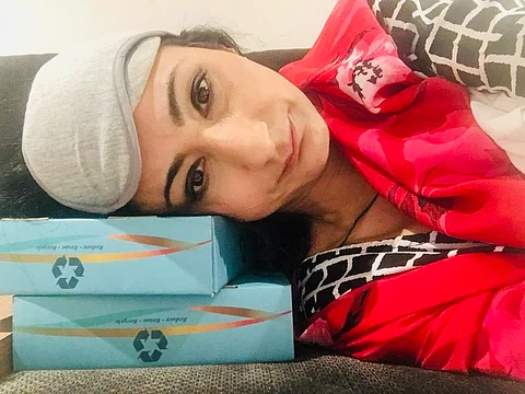 Denied entry to India, deprived of basic facilities and food, a tired Nitasha Koul resting on a bench at Bengaluru airport. Photo/Nitasha Koul via X