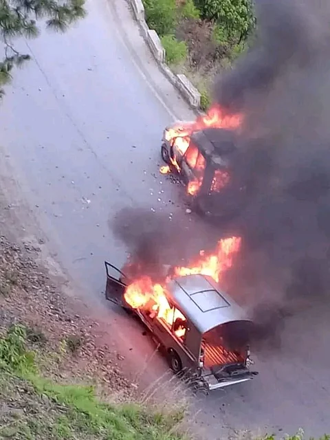 Two police vehicle set on fire by angry protesters on a road leading to Muzaffarbad, on Monday, May 13, 2024, during the protest march.