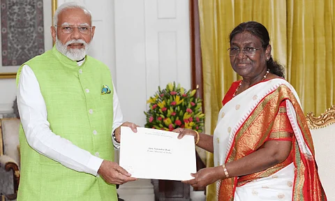 This handout photograph taken on June 5, 2024 and released by the Indian Press Information Bureau (PIB) shows Prime Minister Narendra Modi (L) handing over his resignation along with the Union Council of Ministers (not in picture) to President Droupadi Murmu at presidential palace Rashtrapati Bhavan in New Delhi.
