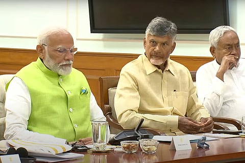 Indian prime minister elect Narendra Modi, left, is sitting next to Telugu Desam Party leader N Chandrababu Naidu, center, and Janata Dal (United) leader Nitish Kumar. Photo/AP