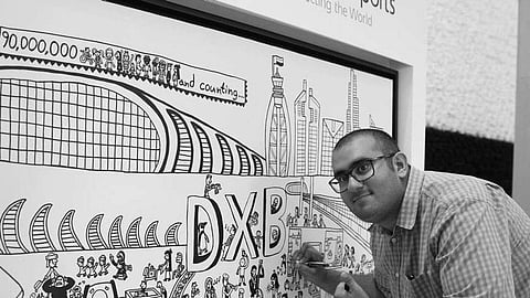 عبدالله لطفي مع إحدى رسوماته