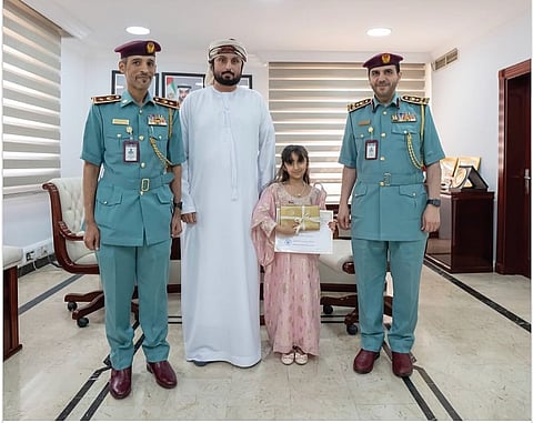 شرطة عجمان تكرم فتاة لأمانتها في إعادة أموال مفقودة
