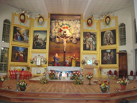 Observe the artistic altar of Indore's Red Church, detailing the life of Christ in colour