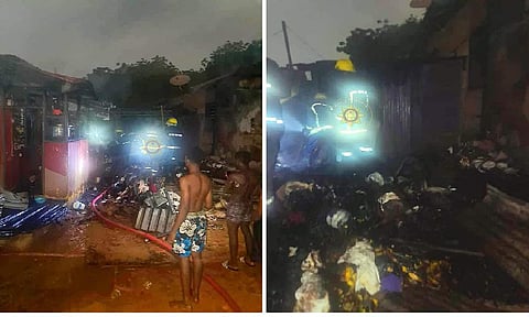 Fire service personnel quenching fire at scene