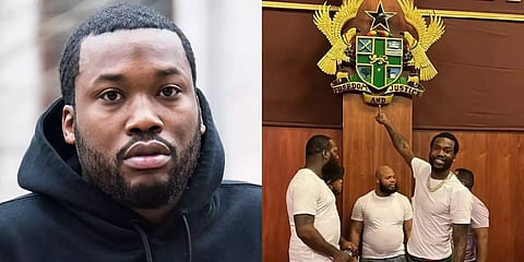 Meek pointing at Ghana's coat of arms