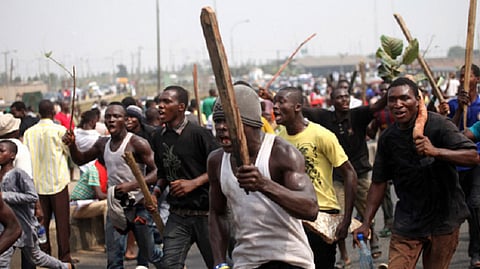 Men carrying sticks in the scene of an unrest
