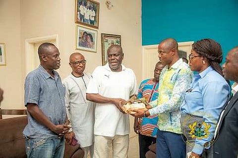 Sellas Tetteh receiving cash donation from Hon Evans Opoku Bobie and his entourage