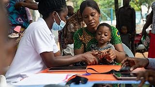 Nurse administering vaccine to a child