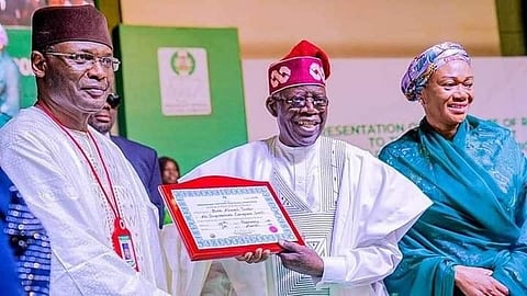 The INEC chairman formally presenting the INEC Certificates of Return to the President-Elect Asiwaju Bola Ahmad Tinubu at the National Collation Center, International Conference Centre, Abuja.