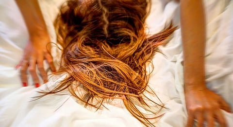 Woman grabbing the sheets