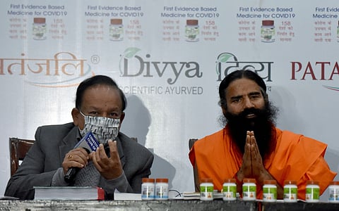 New Delhi, Feb 19 (ANI): Yog Guru Ramdev and Union Health Minister Dr Harsh Vardhan address media during the release of the 'first evidence-based medicine for COVID19 by Patanjali', at Constitution Club of India in New Delhi on Friday. (ANI Photo)
