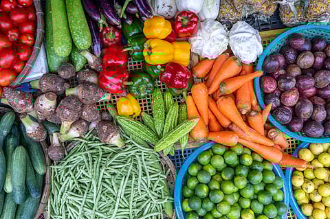Fresh vegetables for sale at street food market in the old town of Hanoi, Vietnam. Close up, top view