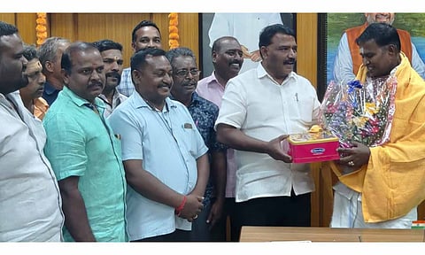 ஏ.யூ.டி.சி. பொதுசெயலாளர் சேது செல்வம் அமைச்சர் சாய்.ஜெ.சரவணன் குமாருக்கு பூங்கொத்து கொடுத்து இனிப்பு வழங்கிய காட்சி.