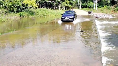 தரைப்பாலத்தை மூழ்கடித்தபடி தண்ணீர் செல்வதையும், அதில் கார் பயணிப்பதையும் காணலாம்.