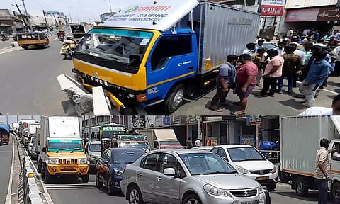 தடுப்பு சுவரில் சரக்கு வேன் மோதி நிற்பதை படத்தில் காணலாம்.அணிவகுத்து நிற்கும் வாகனங்கள்.