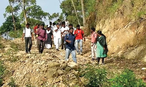 கொடைக்கானல் வெள்ளகவி கிராமத்துக்கு மலைப்பாதையில் நடந்து செல்லும் நீதிபதி மற்றும் வக்கீல்கள்.