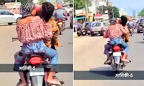 ஓடும் 'பைக்'கில் முத்த மழை பொழிந்த காதல் ஜோடி