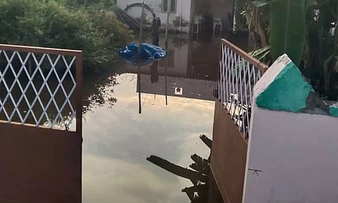 மழைநீர் வீட்டை சூழ்ந்திருப்பதை படத்தில் காணலாம்.