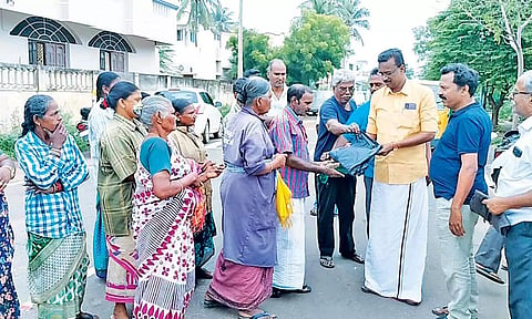 கவுன்சிலர் நீலகண்டன் மழைகோட் வழங்கினார்.