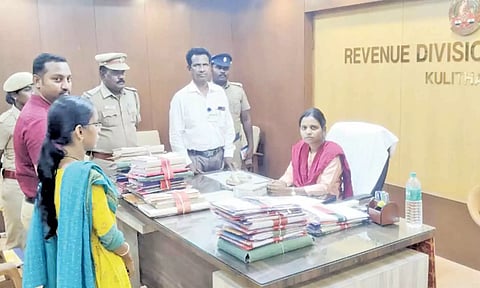 பறிமுதல் செய்யப்பட்ட பணத்தை குளித்தலை ஆர்.டி.ஓ. தனலட்சுமியிடம் ஒப்படைக்கப்பட்ட காட்சி.