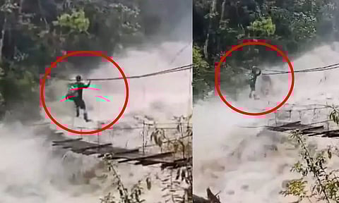 VIDEO: காட்டாற்று வெள்ளத்திற்கு நடுவே தொங்கு பாலத்தில் ஆற்றை ஆபத்தான முறையில் கடக்கும் நபர்