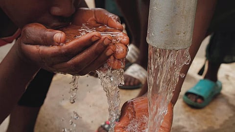 A high-impact photo of the affected neighborhood showing the proximity of drainage lines to residential water taps, or a somber shot of health teams providing "on the spot" first aid to residents.