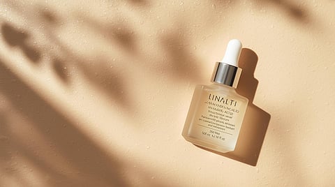 Hyaluronic acid serum bottle with dropper on a minimal background representing hydration, glowing skin, and modern skincare routine