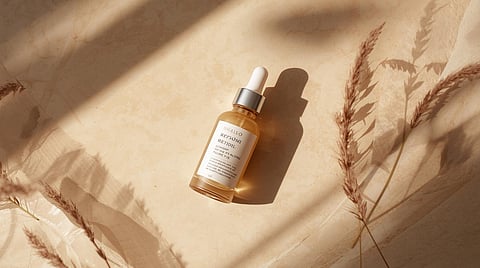 Retinol serum bottle styled in a minimal editorial flatlay representing skincare for acne, pigmentation, and anti-aging.