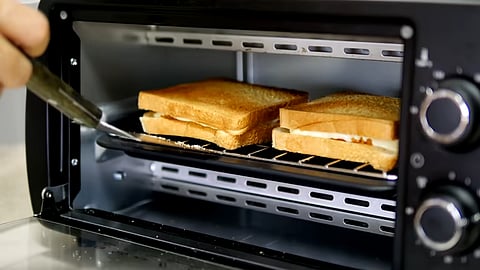 An air fryer relies on rapid hot-air circulation for cooking food while an OTG works like a small electric oven equipped with a heating element at the top and bottom.