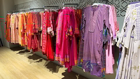 Two confident Indian women styled in ethnic wear and contemporary western dresses representing BIBA and AND fashion on International Women’s Day.