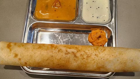 Authentic buttery Benne Dosa is served with coconut chutney and potato filling.