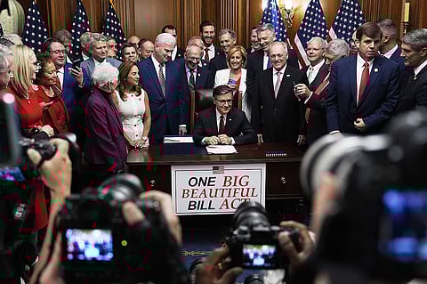 Speaker of the House Mike Johnson, R-La., surrounded by Republican members of Congress, signs President Donald Trump's signature bill of tax breaks and spending cuts. (AP Photo/Julia Demaree Nikhinson)