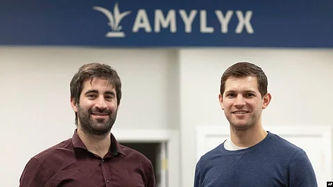This 2018 photo provided by Amylyx shows company co-founders Joshua Cohen, left, and Justin Klee in Cambridge, Mass. A closely watched experimental drug for Lou Gehrig’s disease is getting an unusual second look from U.S. regulators (Image Source- VOA)
