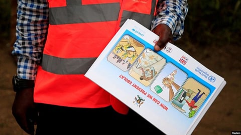 An Ugandan health worker shows an informational flyer on Ebola virus and how to prevent its spread to the community of Kirembo village, near the border with the DRC, in Kasese district, Uganda, June 15, 2019 (Image source-VOA)