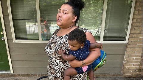 Louana Joseph and her daughter, Marlie, outside their former apartment complex in southwestern Atlanta. Joseph moved out of the unit because she suspected the gray and brown splotches that were spreading through her apartment were mold. After rents soared during the pandemic, some families were forced to live in substandard housing, which increased their risk of developing health problems such as asthma and lead poisoning.