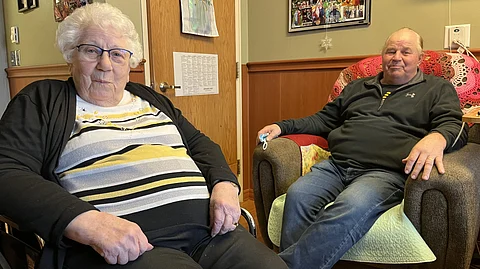 Marjorie Kruger visits with son Dan White in her new room at the Evangelical Lutheran Good Samaritan Society nursing home in Waukon, Iowa. Kruger transferred to the Waukon facility in September 2022, because Good Samaritan was closing its Postville, Iowa, home, where she lived for six years.