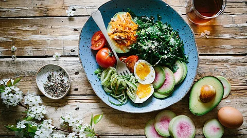 Eating foods such as berries, apples, carrots, and leafy green vegetables including spinach because they have nutrients that boost eye health (Unsplash)