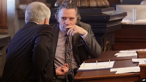 Kansas Senate President Ty Masterson, right, R-Andover, confers with Senate Majority Leader Larry Alley, left, R-Winfield, ahead of a Senate vote on overriding Gov. Laura Kelly's veto of a bill banning transgender athletes from girl's and women's sports,