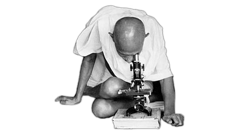 At the core of the MGIMS logo, the logo portrays the iconic Mahatma Gandhi, his gaze fixated intently on a mono-ocular microscope. (Image credit: MGIMS official website)