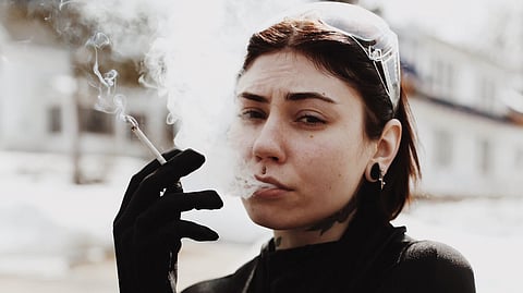 A woman smoking, which might be a Menthol cigarette. (Representation Image: Unsplash)