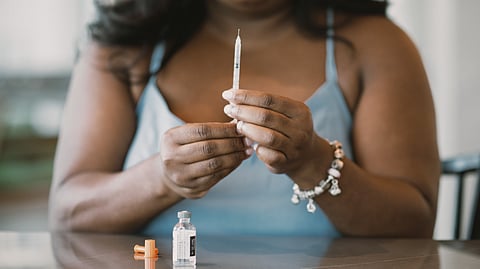Mila Clarke poses at home in Houston with a vial of insulin, which she uses to treat her diabetes. Clarke was
initially diagnosed with Type 2 diabetes before learning four years later she had an autoimmune form of the
disease. (Brandon Thibodeaux for KFF H
ealth News)