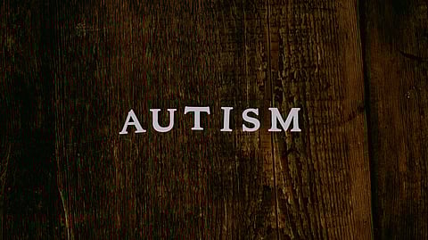 Word 'Autism' displayed on a wooden background