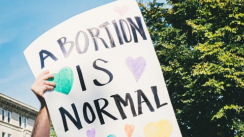 A mother guides her child past a corridor adorned with 'hina' dolls at a Shinto shrine in Tokyo, on March 3, 2023.