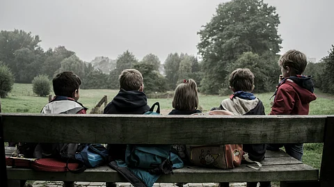 Kids sitting on a bench