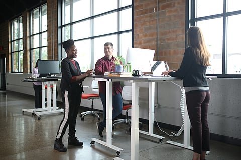 Ergonomic furniture often includes features that promote movement, such as sit-stand desks and flexible seating options. (Representational image: Unsplash)