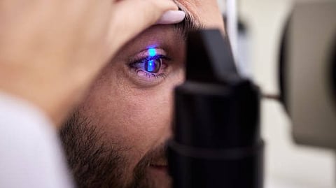 A person getting his eye checked at optometrist.